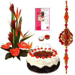 Mesmerizing Combo Gift Pack of Seasonal Flowers Bouquet, Bakery Fresh Cake and Card with free Rakhi, Roli Tilak and Chawal